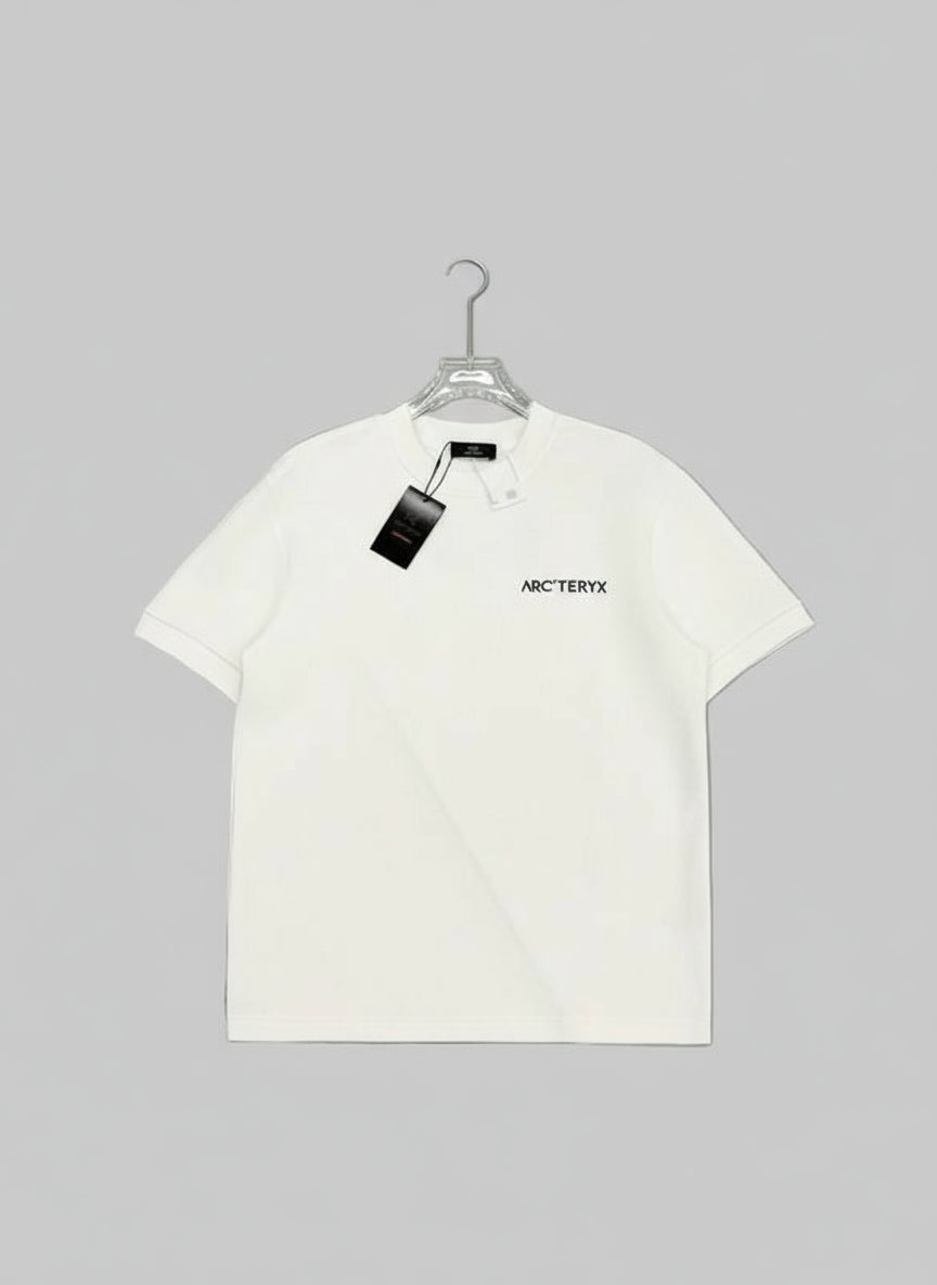 White t-shirt with a brand logo on a gray surface